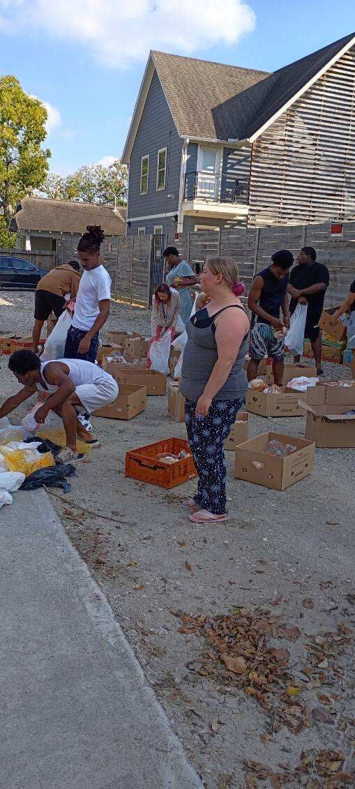 Serving neighbors at an outdoor food distribution